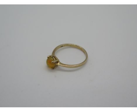 A hallmarked 9ct gold and fire opal ring, set with a small round cabachon polished opal approx 6mm in diameter, ring size P, 