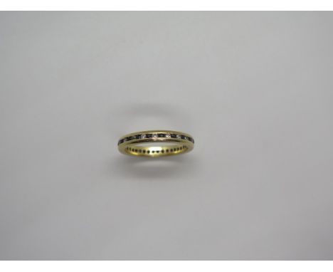 An 18ct gold diamond and sapphire eternity ring channel set with alternating stones arround the entire circumference, size K 