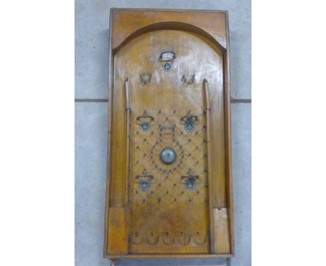 A late 19th century fruit wood bagatelle game with left hand hand pull and bells, two missing, 70x35cm 