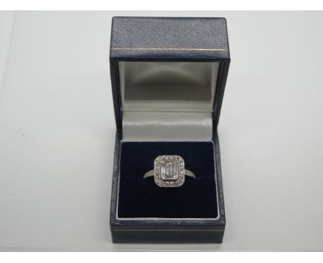 A 18ct white gold diamond square cluster ring with four rectangular baguette diamonds to the centre with smaller baguette cut