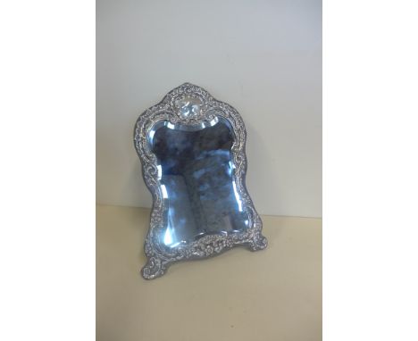 An embossed silver mounted easel back table mirror, 32cm tall x 23cm - mirror good, some general usage wear to frame 