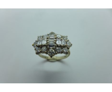 An 18ct gold Oval cluster ring - the fancy oval cluster comprising a central cross formation, comprising a total of seven bag