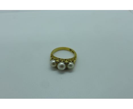 An 18ct yellow gold three pearl ring set with four small diamonds , ring size K, approx 5 grams, some pitting to pearls, othe