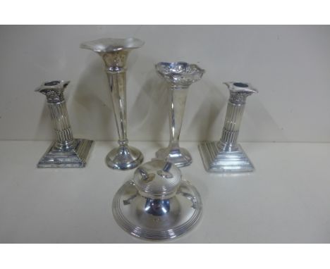 A pair of weighted silver candlesticks, two silver weighted vases, tallest 7cm and a silver weighted capstan inkwell, one can