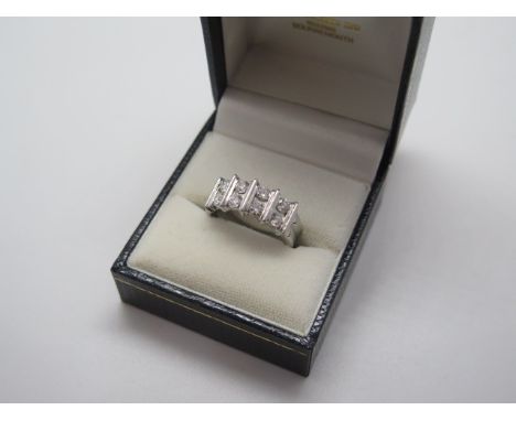 A hallmarked 18ct white gold eight stone diamond bar ring, size N, approx 7.8 grams, total carat approx 1ct, clarity estimate