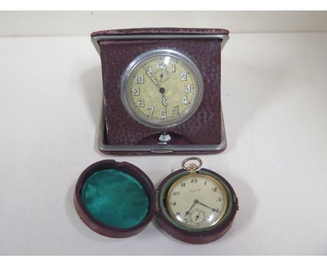 An 8 day Swiss movement travelling clock in a case together with a Swiss watch in case with fitted compass 