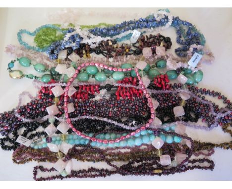 A collection of bead necklaces to include freshwater pearls, garnets, rose quartz etc, also cut and polished amethyst stones 