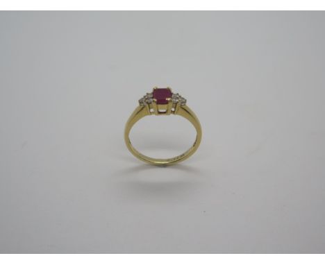 An 18ct hallmarked ruby and diamond set ring, diamonds approx 0.12ct, ring size K/L, approx 2.9 grams, in good condition 