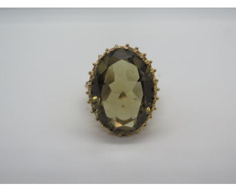 A fully hallmarked 9ct gold smokey quartz ring, the large oval stone measuring approx 26x13mm, size S, weight 11.6 grams, ver