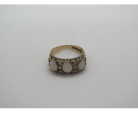 A 9ct gold opal and diamond ring, set with three oval opals divided by a total of six small diamonds, size O, weight 4.2 gram