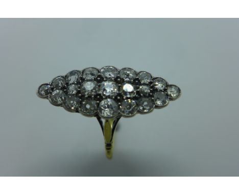 A stunning antique 18ct gold and diamond navette cluster ring set with twenty-one old mine cut diamonds, totaling approx 1.7 