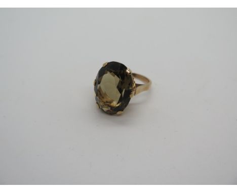A large oval smokey quartz 9ct gold ladies ring stone measures 22x12mm approx, ring size L 2/2 - stamped 9ct, weight 8.3 gram