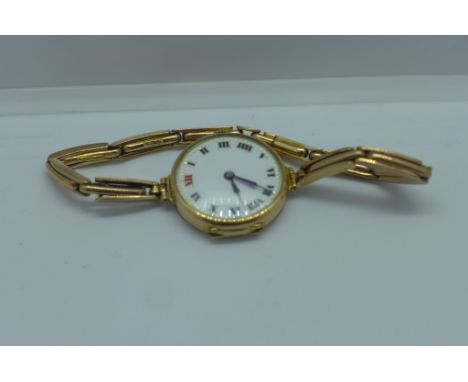 A 9ct gold manual wind wristwatch on a 9ct sprung strap with enamel dial running, total weight approx 18.6 grams 