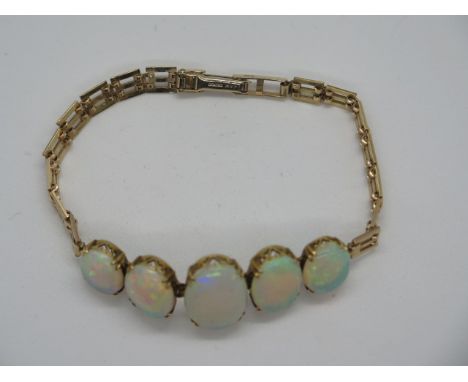A 9ct gold and opal bracelet set with five large graduated opals, the largest approx 17x12mm, bracelet length 19cm, weight 13