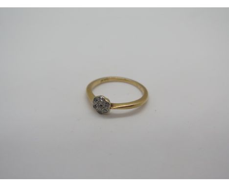 An 18ct diamond cluster ring with seven small stones, in platinum mount, stamped 18ct, size J 1/2, good clean condition - app