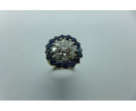 A diamond and sapphire three tier round cluster ring, the central round brilliant cut diamond measuring approx 5.71mm - 5.74m