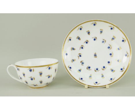 A NANTGARW PORCELAIN HENSOL CASTLE CUP &amp; SAUCER painted with scattered blue enamel berries and gilded foliage within a so