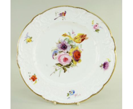 A NANTGARW PORCELAIN PLATE of lobed form, the border moulded with c-scrolls, flowers and tied ribbons together with five indi
