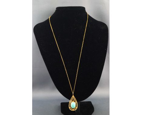 A yellow metal pendant set with a natural turquoise cabochon. Tests indicate 18ct gold. Suspended from a gold plated curb lin