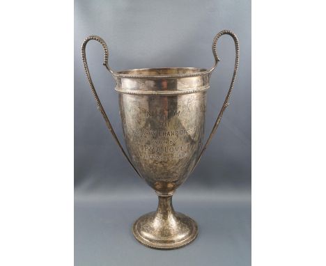 A silver two handled trophy cup, with two beaded handles on a flared foot, engraved "A.A.M. 1911, 1 Mile Army Championship Wo