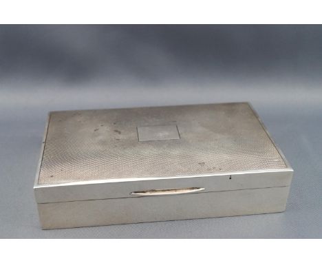 A silver cigarette box with engine turned decoration to cover, Birmingham 1969, 14.5cm wide