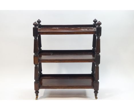 A late Victorian mahogany three tier buffet on turned supports and ceramic casters, 101cm high x 83cm wide x 43cm deep