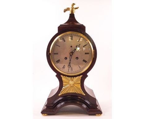 A 19th century mahogany balloon shaped mantel clock, the eight day movement with bell strike, the case surmounted by a gilt m