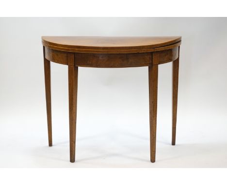 A George III mahogany demi-lune card table with boxwood stringing and square tapering legs, 73.5cm high x 90cm wide x 45cm de