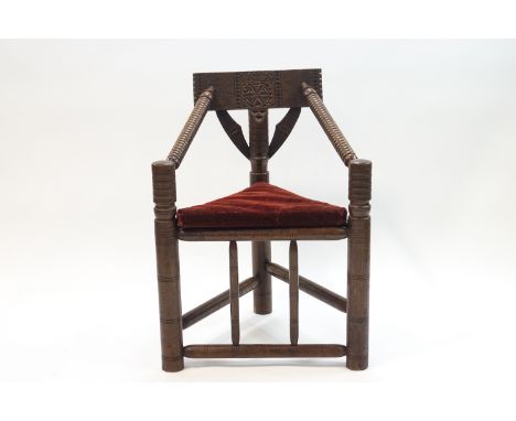 A late Victorian turned oak turner's chair, Folk art carved decoration, bobbin turned arms and triangular panel seat, 64cm wi