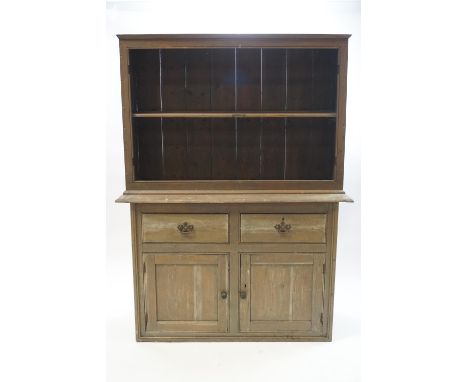 A Victorian stained pine dresser, the panel back rack with single shelf over two drawers and cupboard base, 187cm high x 136c