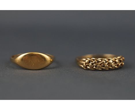 A selection of two yellow gold dress rings to include a hallmarked 9ct gold keeper ring Size M 1/2 and a hallmarked 18ct gold