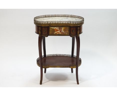 A French kidney shaped mahogany and gilt metal mounted two tier table, the marble top with brass gallery, drawer below and ga