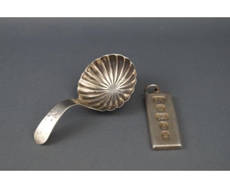 A George III silver caddy spoon by Thomas Willmore, with round fluted bowl, Birmingham 1802, together with a silver ingot pen