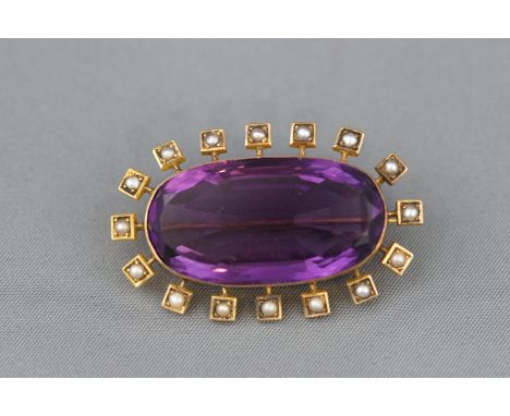 An oval amethyst and seed pearl cluster brooch. Pin and C catch fitting. Tests indicate 18ct gold. Amethyst estimated to weig
