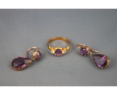 A yellow metal pair of two stone drop earrings each set with amethyst together with a gold plated ring with purple and pale y