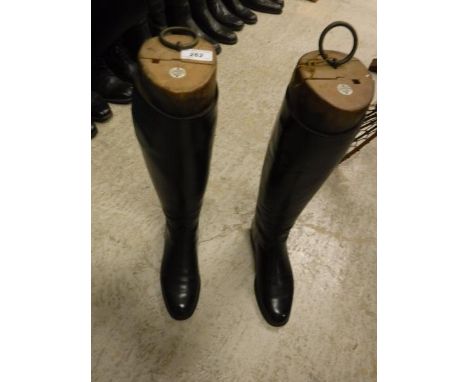 A pair of black leather riding boots with wooden trees, bearing ivorine labels inscribed "Jackson 4 Avery Row, Grosvenor Stre