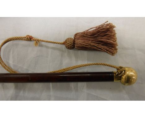 A ladies side saddle whip, the yellow metal mount with engine turned decoration and tassel attached to a malacca shaft