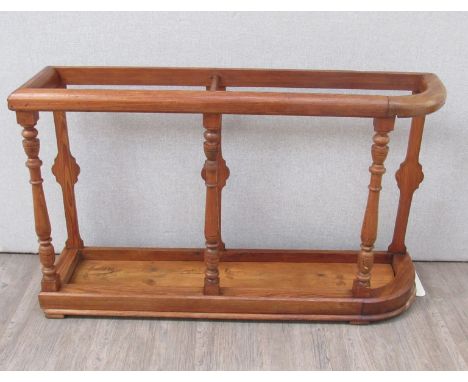 A 19th Century country house pitch pine large stick stand on turned supports 