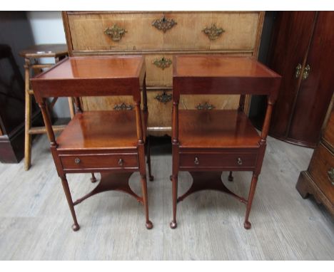 A pair of Georgian style mahogany bedside tables/lamp tables, each with a small drawer to the undertier, on slender tapering 