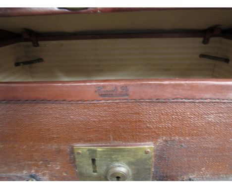 A canvas and leather steamer trunk by Harrods, monogrammed A.L.H, 76cm x 51cm