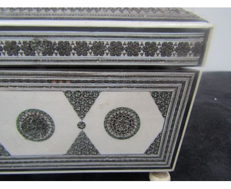 A 19th Century Anglo-Indian sewing box of shallow sarcophagus form, elaborately decorated with metal mosaic patterns interspe