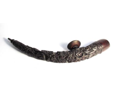 A highly carved Chinese opium pipe of curved form, 43cm long approx 