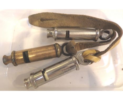 Three vintage whistles all with stamped military arrow, one dated 1952