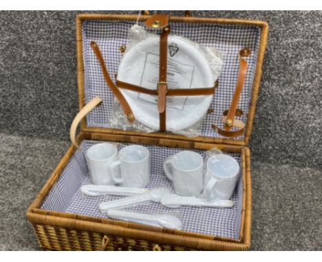 Vintage wicker picnic hamper containing plastic cups, plates &amp; cutlery