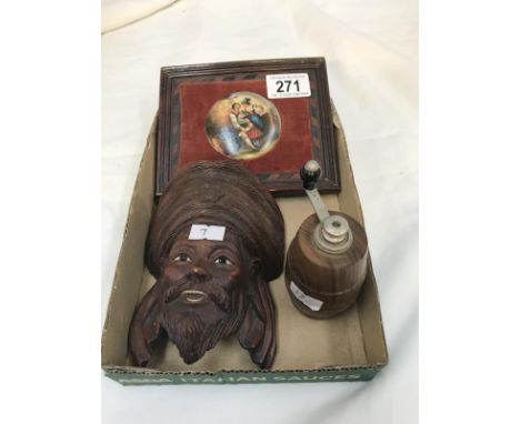 A carved wooden mask, a wooden nutmeg grinder and a small pot lid in frame