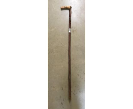 A silver banded walking stick
