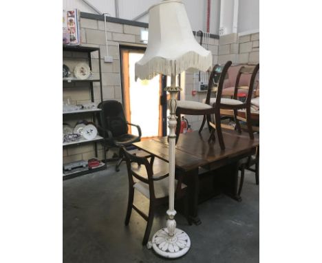 An ormalu style painted standard lamp with shade