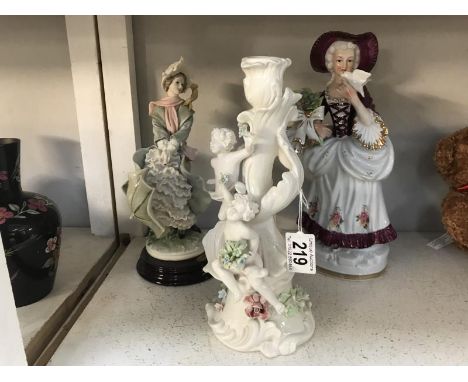 A cherub candlestick and 2 figurines