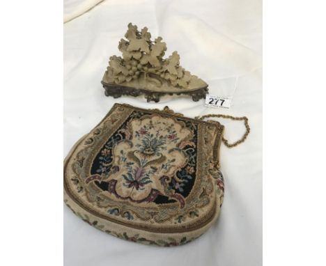 A tapestry bag with mirror and soapstone carving