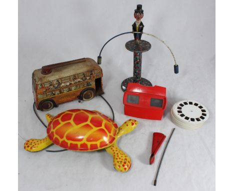 A Brimtoy tinplate clockwork double-decker trolley bus, number '657', 20cm and a Mobo Tortoise 'I lead you follow' tin plate 